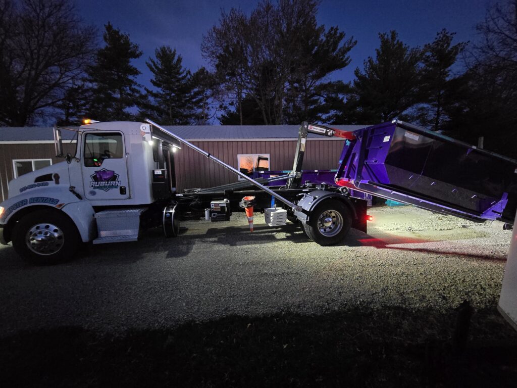 a roll off truck dumpster on the back. hooklift